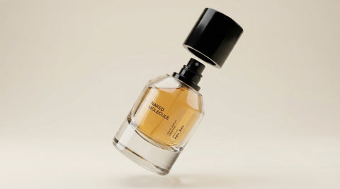 Perfume bottle with black cap on a beige background